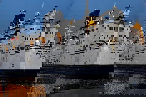 Ship "Africa Mercy" docked at port, displaying "mercyships.org" on its side.